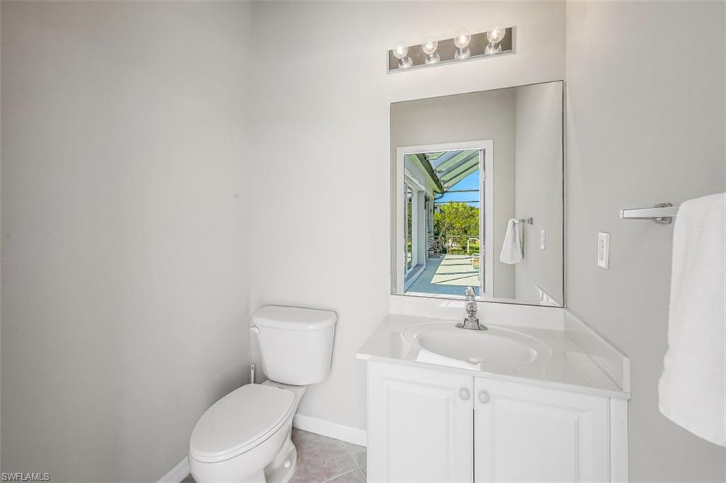 21641 Helmsdale Run Estero, FL 33928 - Photo 13 of 35 a bathroom with a toilet sink and mirror