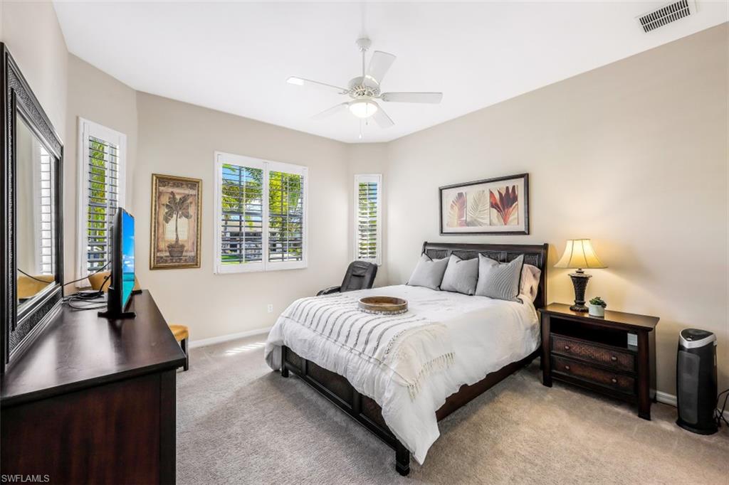 21641 Helmsdale Run Estero, FL 33928 - Photo 16 of 35 a bedroom with a bed and a dresser next to a window