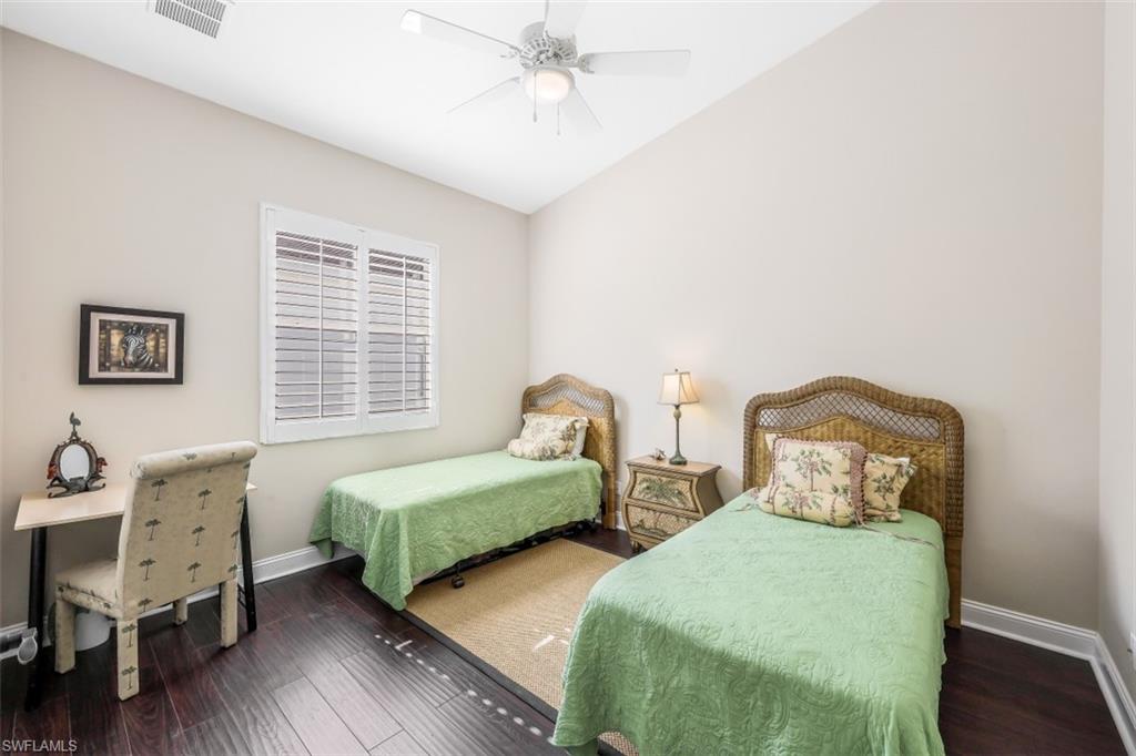21641 Helmsdale Run Estero, FL 33928 - Photo 18 of 35 a bedroom with two beds and wooden floor