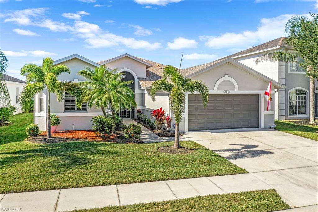 21641 Helmsdale Run Estero, FL 33928 - Photo 22 of 35 a front view of a house with a yard and garage
