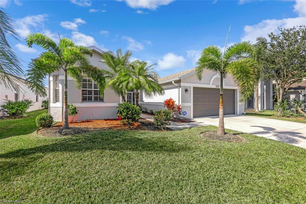 21641 Helmsdale Run Estero, FL 33928 - Photo 23 of 35 a house with palm tree in front of it