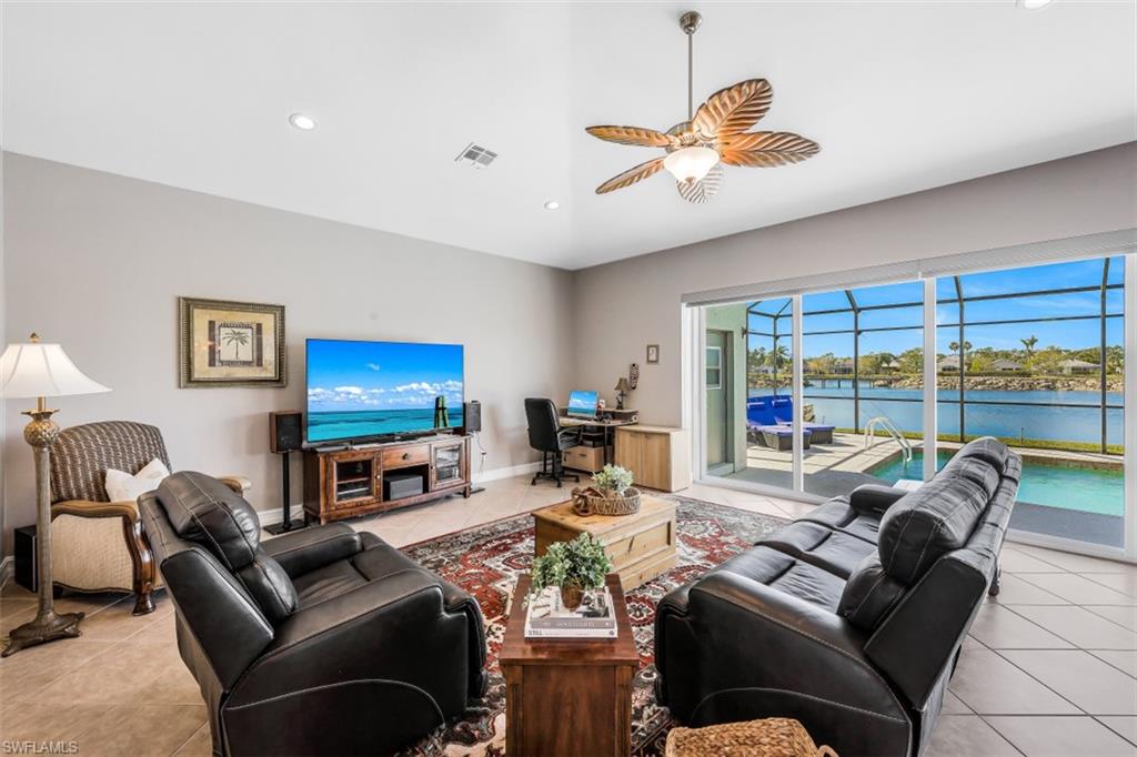 21641 Helmsdale Run Estero, FL 33928 - Photo 5 of 35 a living room with furniture a ceiling fan and a large window