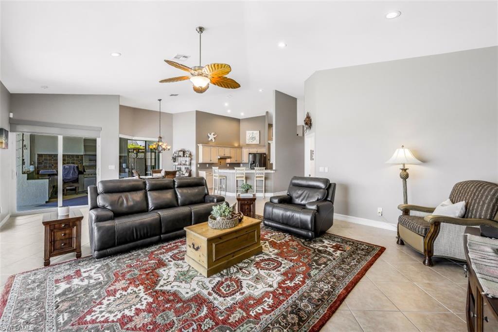 21641 Helmsdale Run Estero, FL 33928 - Photo 6 of 35 a living room with furniture kitchen view and a chandelier