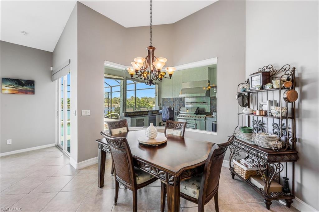 21641 Helmsdale Run Estero, FL 33928 - Photo 9 of 35 a dining room with furniture a chandelier and window