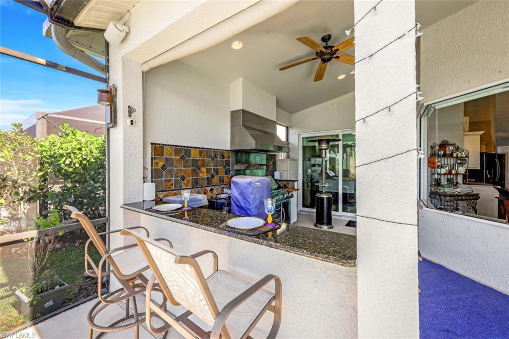 21641 Helmsdale Run Estero, FL 33928 - Photo 10 of 35 a kitchen with a table chairs refrigerator and sink