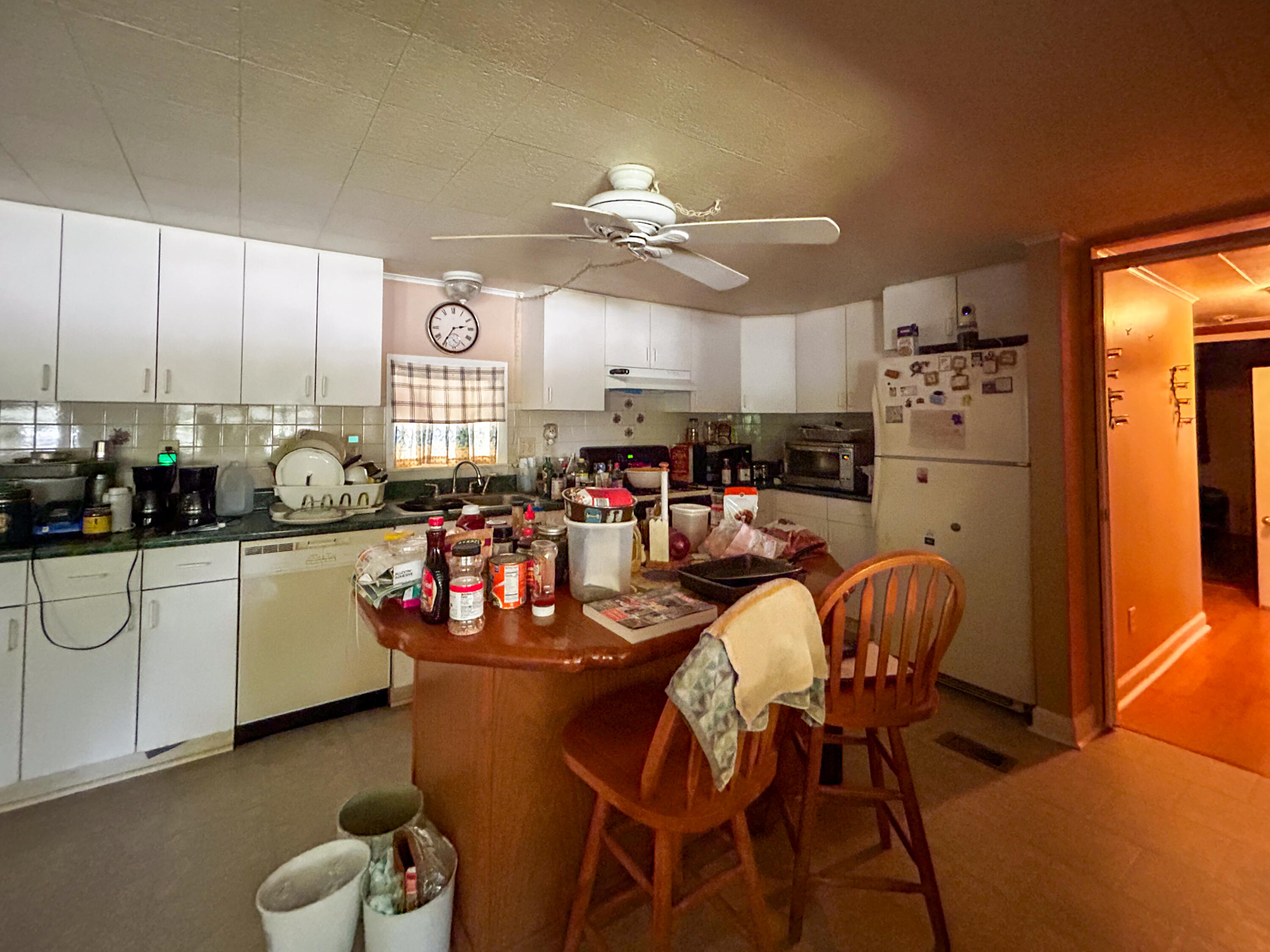 2446 Southeast Carroll Street Stuart, FL 34997 - Photo 15 of 37 a kitchen with stainless steel appliances granite countertop a dining table chairs sink and stove top oven