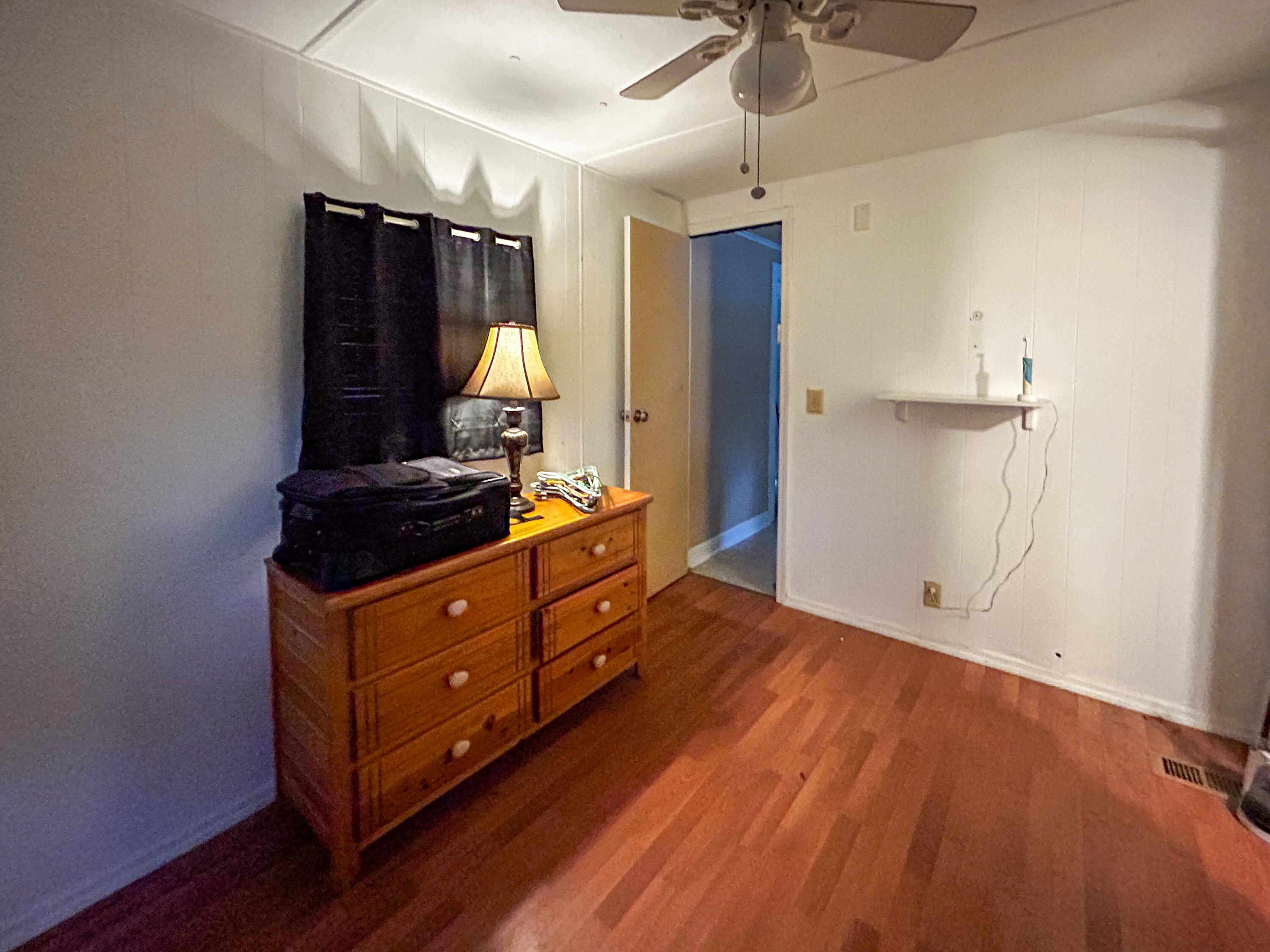 2446 Southeast Carroll Street Stuart, FL 34997 - Photo 17 of 37 a room with a dresser and a mirror