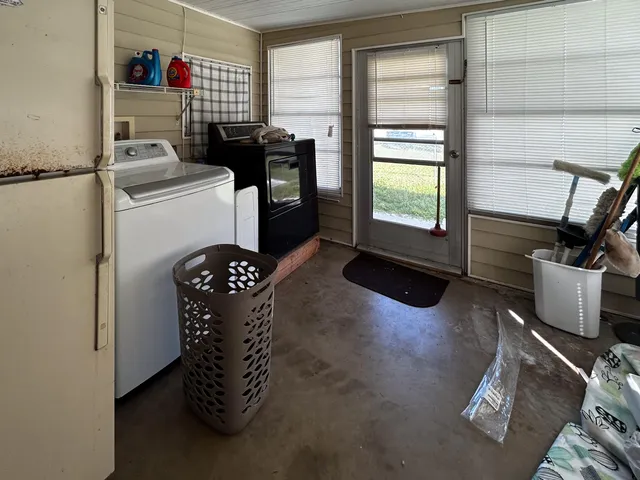 a kitchen with a refrigerator and a stove