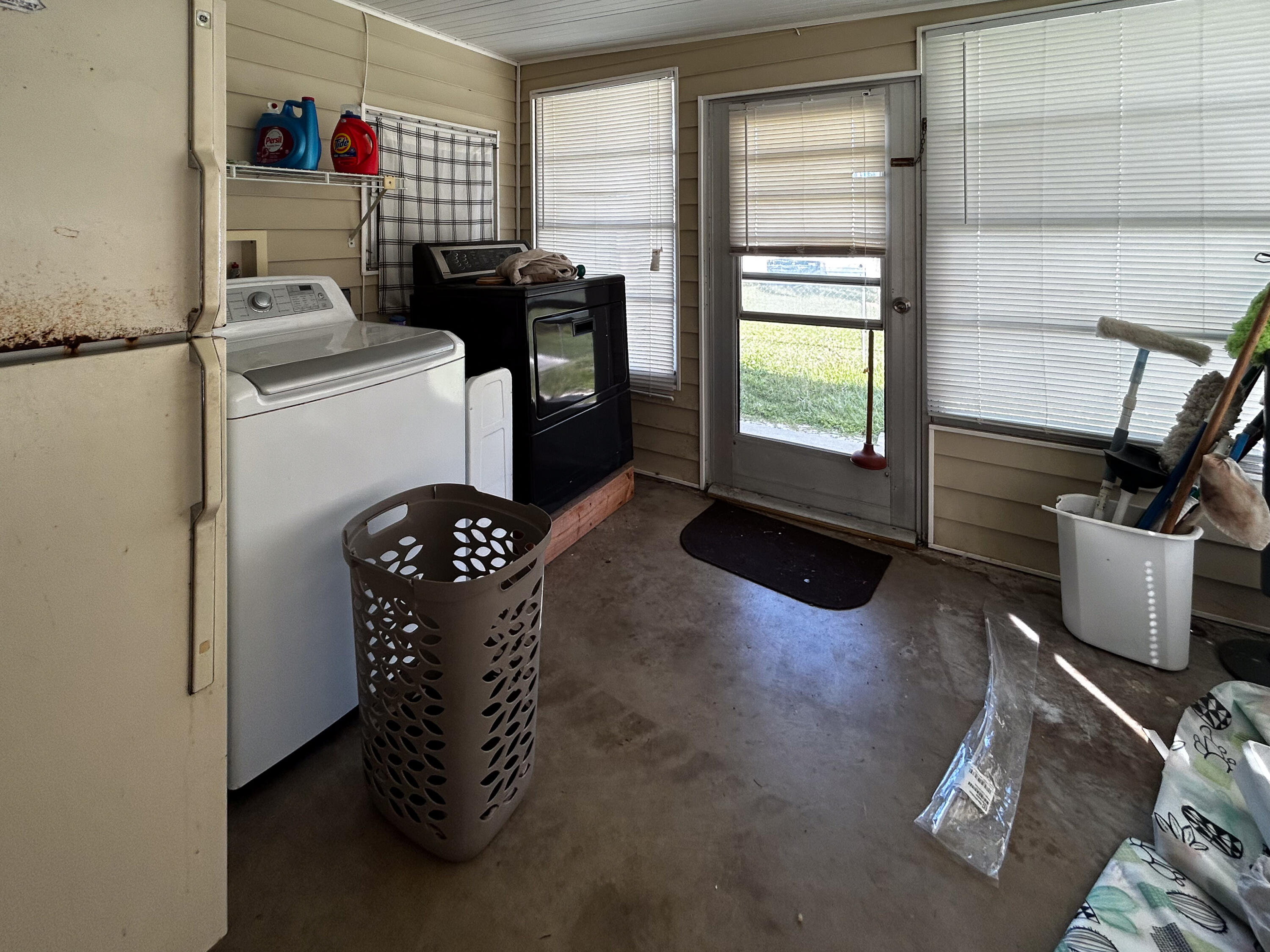2446 Southeast Carroll Street Stuart, FL 34997 - Photo 29 of 37 a kitchen with a refrigerator and a stove