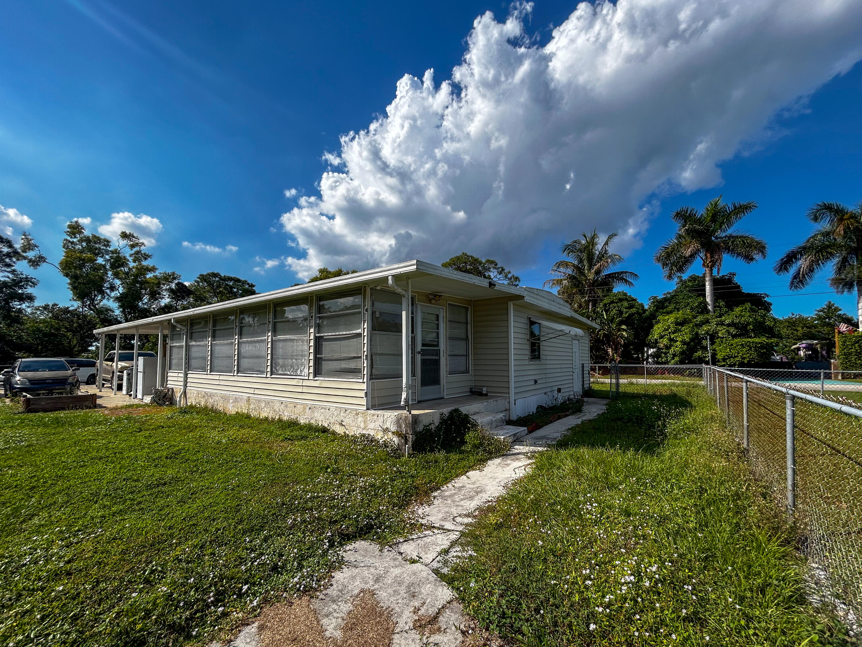 2446 Southeast Carroll Street Stuart, FL 34997 - Photo 31 of 37 a view of a house with a yard