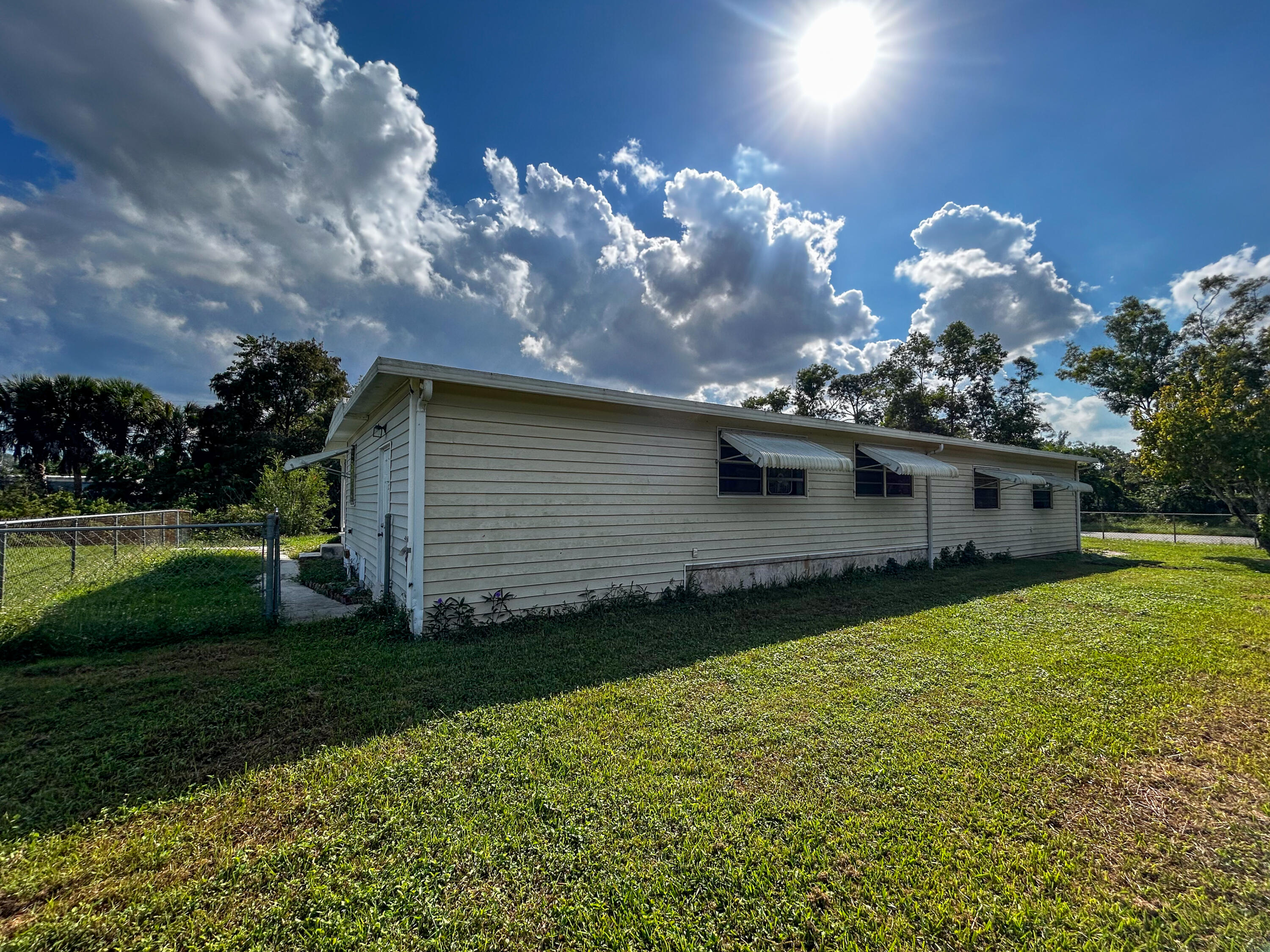2446 Southeast Carroll Street Stuart, FL 34997 - Photo 34 of 37 a front view of a house with a yard