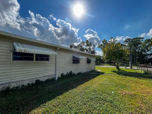 a view of a porch in front of house with a yard