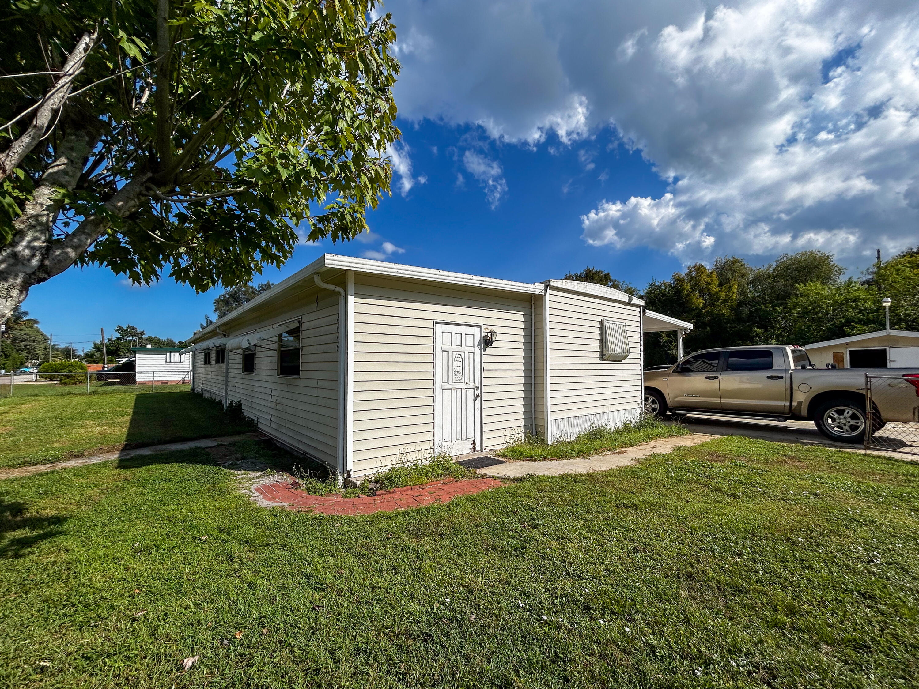 2446 Southeast Carroll Street Stuart, FL 34997 - Photo 4 of 37 a view of a house with a yard