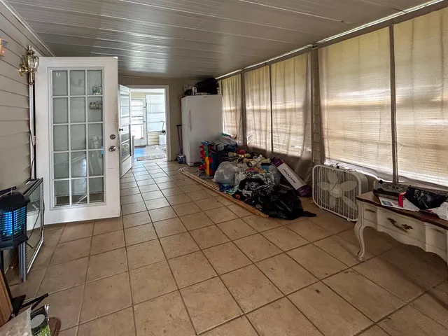 a room with gym equipment and a large window