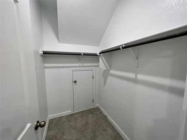 an empty room with a window and wooden floor