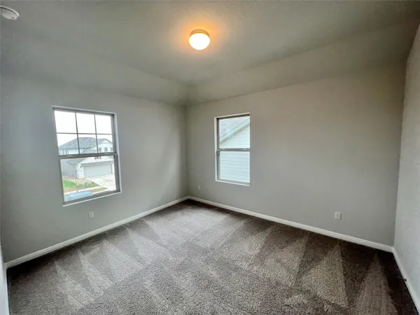 an empty room with windows and closet
