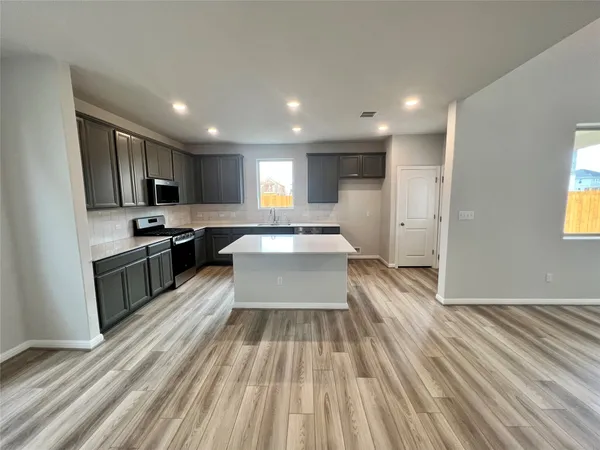 a living room with hard wood floors and furniture or kitchen