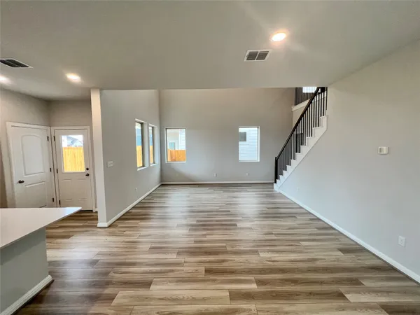 a large kitchen with stainless steel appliances kitchen island granite countertop a sink and cabinets