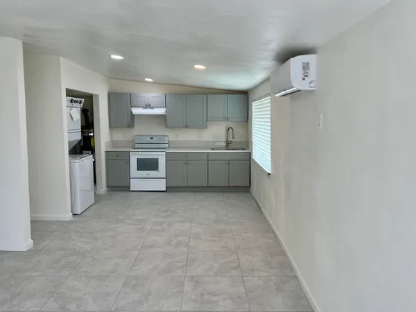 a large kitchen with a stove top oven and refrigerator
