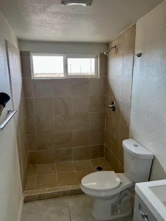 a bathroom with a toilet and a shower