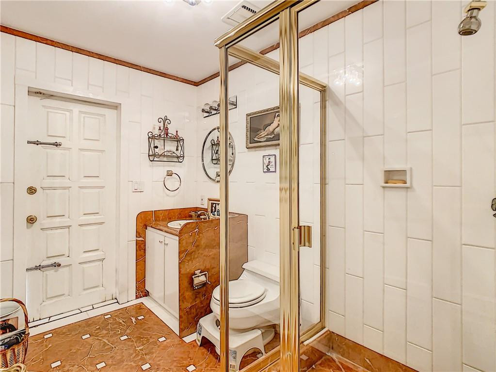 1234 Funston Street Hollywood, FL 33019 - Photo 16 of 23 a bathroom with a sink toilet and shower