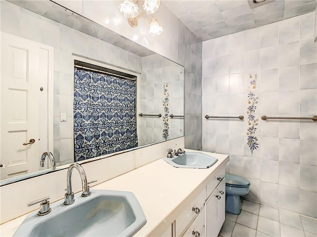 1234 Funston Street Hollywood, FL 33019 - Photo 18 of 23 a bathroom with a sink and a large mirror