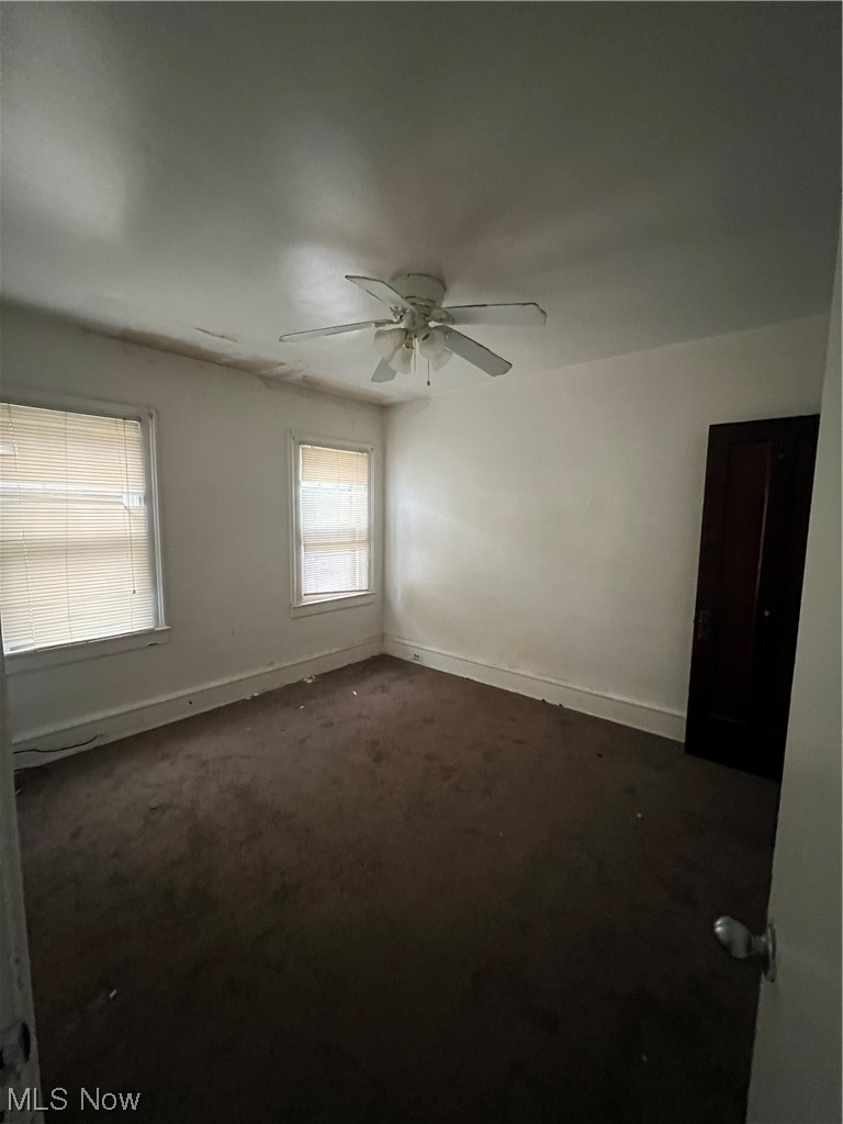 1717 Compton Road Cleveland Heights, OH 44118 - Photo 19 of 24 Unfurnished room with ceiling fan and dark colored carpet