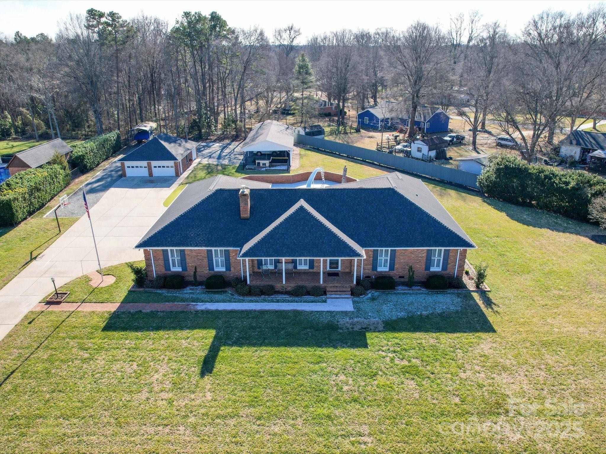 7169 Pleasant Grove Road Charlotte, NC 28216 - Photo 1 of 48 a view of a house with pool and chairs