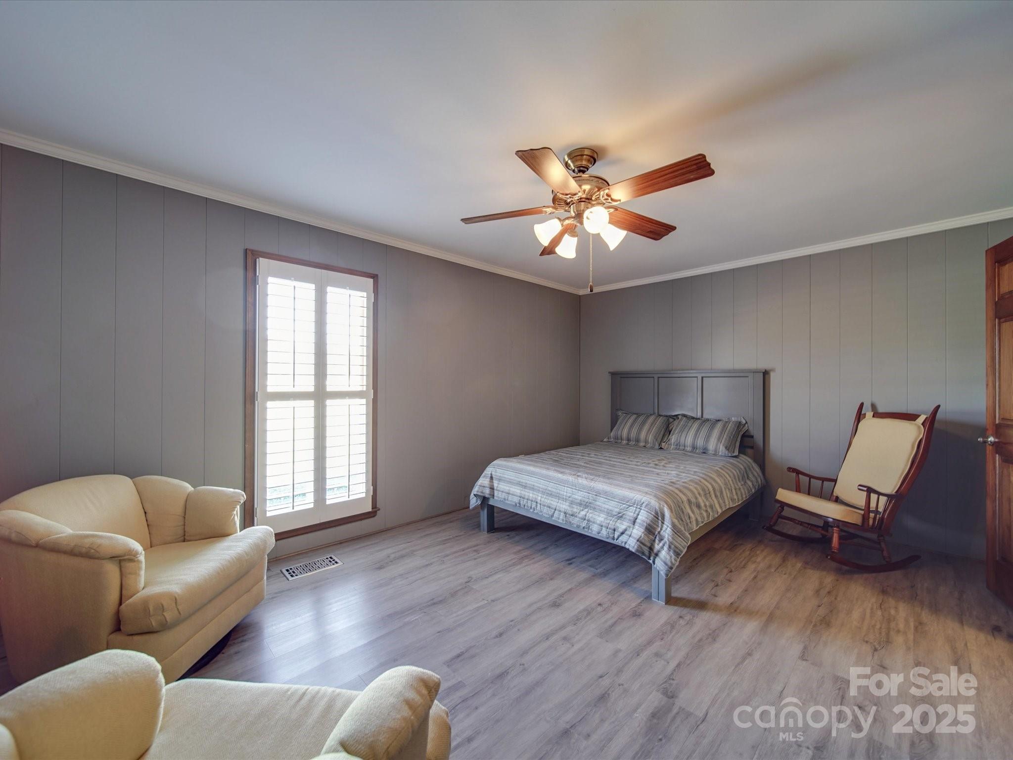 7169 Pleasant Grove Road Charlotte, NC 28216 - Photo 17 of 48 a spacious bedroom with a bed couch and window