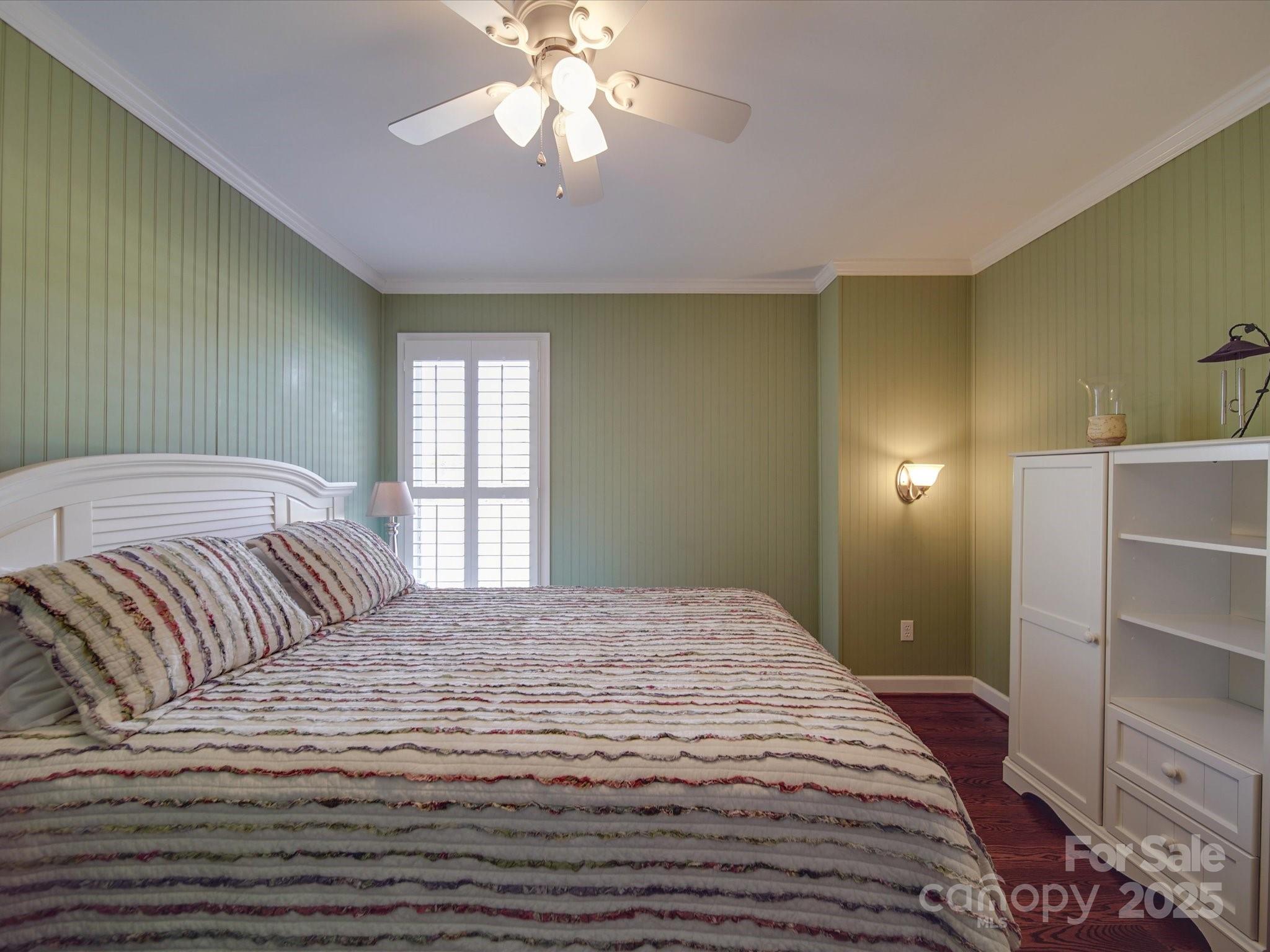 7169 Pleasant Grove Road Charlotte, NC 28216 - Photo 19 of 48 a bedroom with a large bed and a chandelier