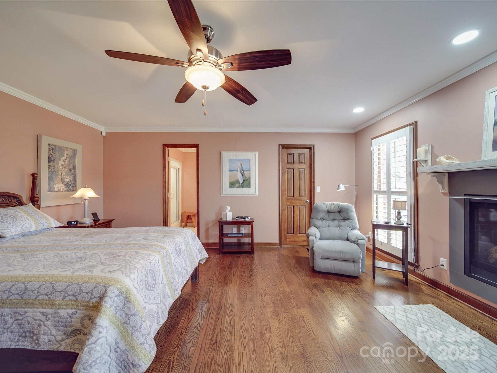 7169 Pleasant Grove Road Charlotte, NC 28216 - Photo 21 of 48 a spacious bedroom with a bed and a chandelier
