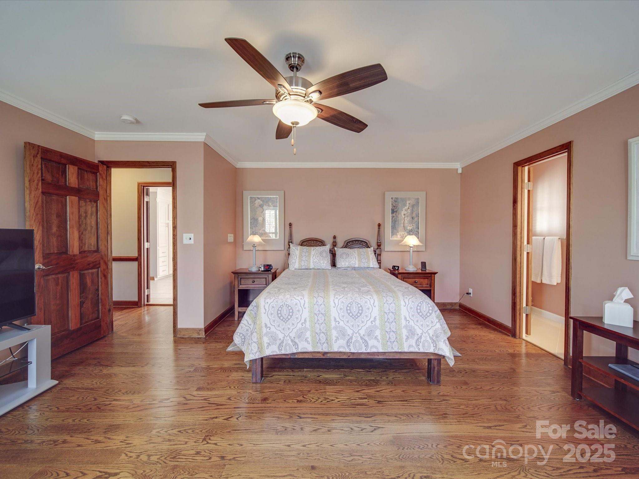 7169 Pleasant Grove Road Charlotte, NC 28216 - Photo 22 of 48 a bedroom with a bed and wooden floor