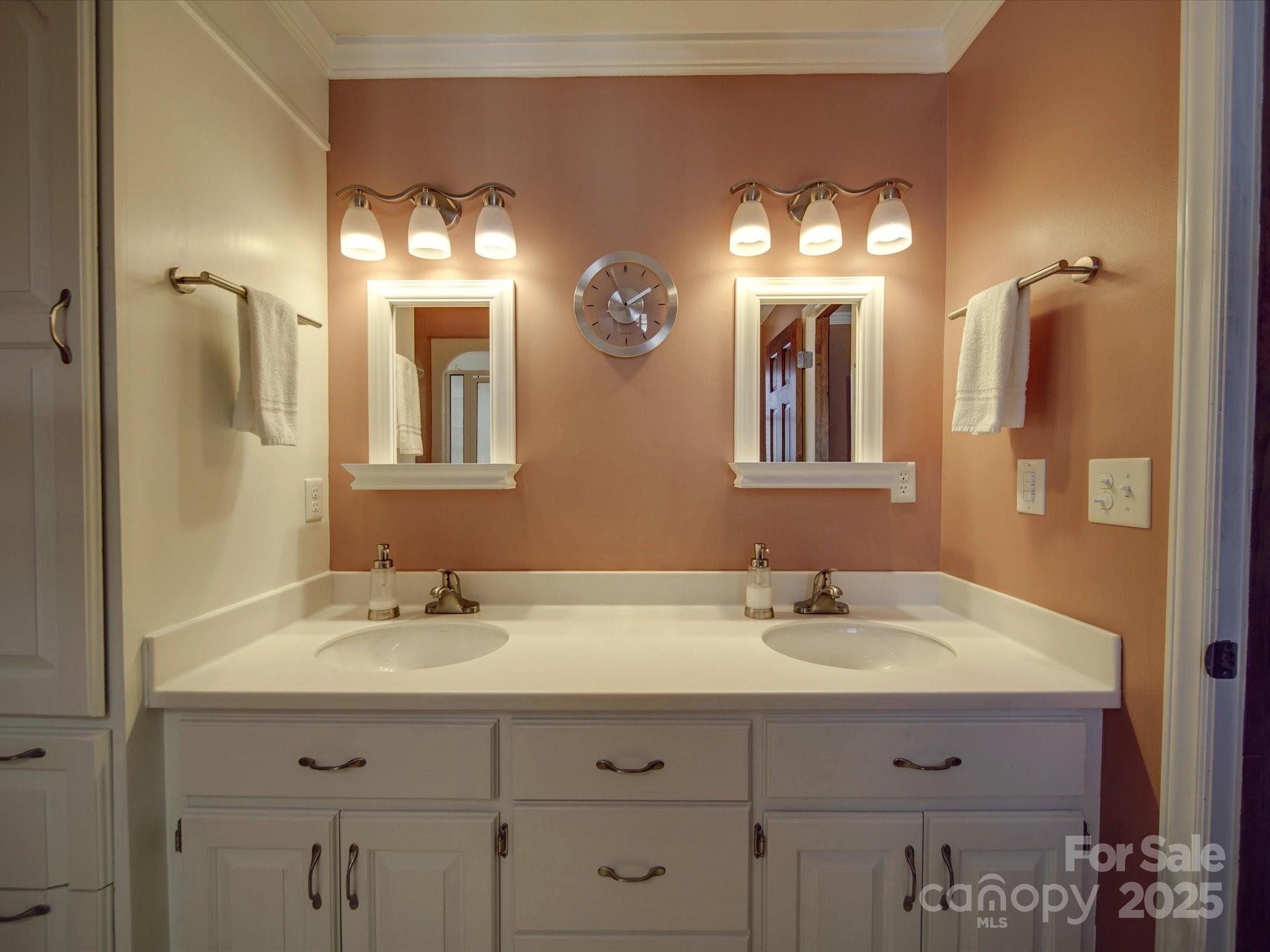 7169 Pleasant Grove Road Charlotte, NC 28216 - Photo 25 of 48 a bathroom with double vanity sinks and a mirror