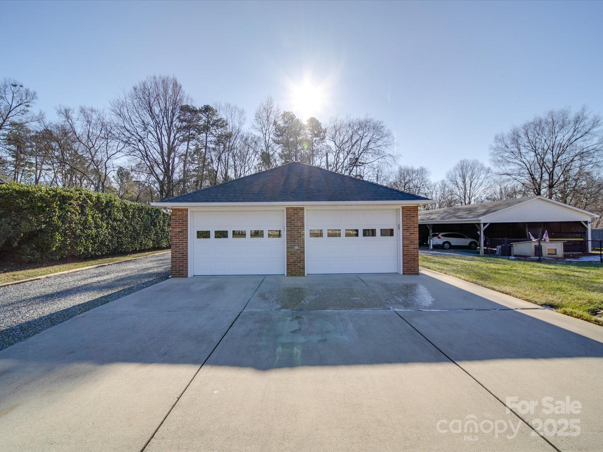 7169 Pleasant Grove Road Charlotte, NC 28216 - Photo 38 of 48 a view of a house with a yard and large tree