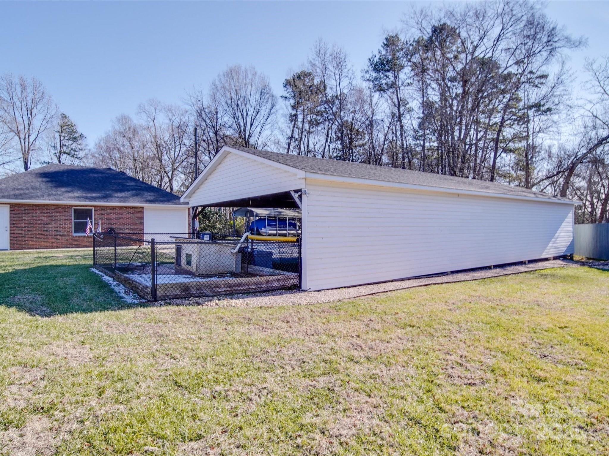 7169 Pleasant Grove Road Charlotte, NC 28216 - Photo 39 of 48 a view of a house with a yard and garage