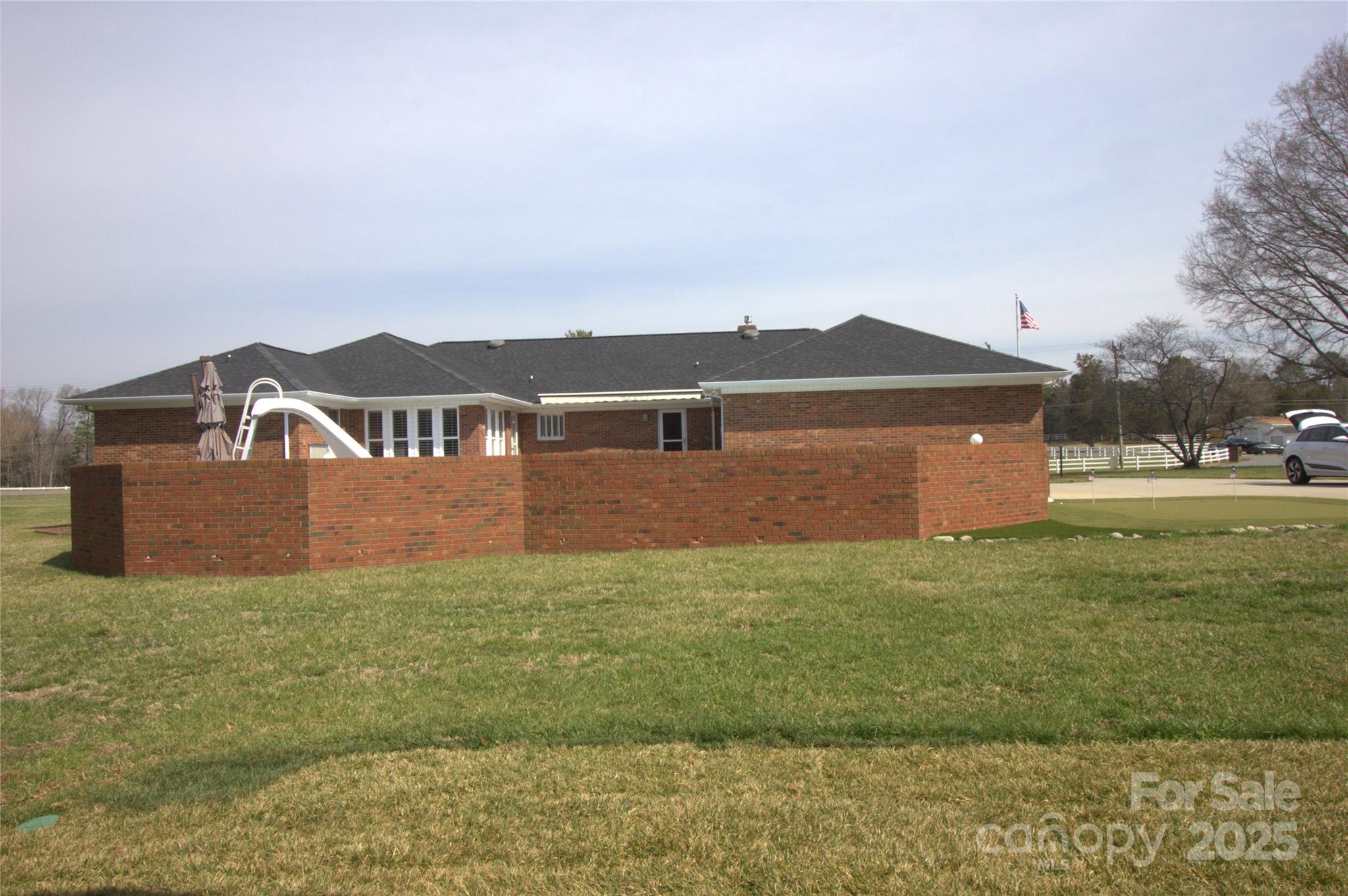 7169 Pleasant Grove Road Charlotte, NC 28216 - Photo 43 of 48 a view of a house with a yard and a large tree