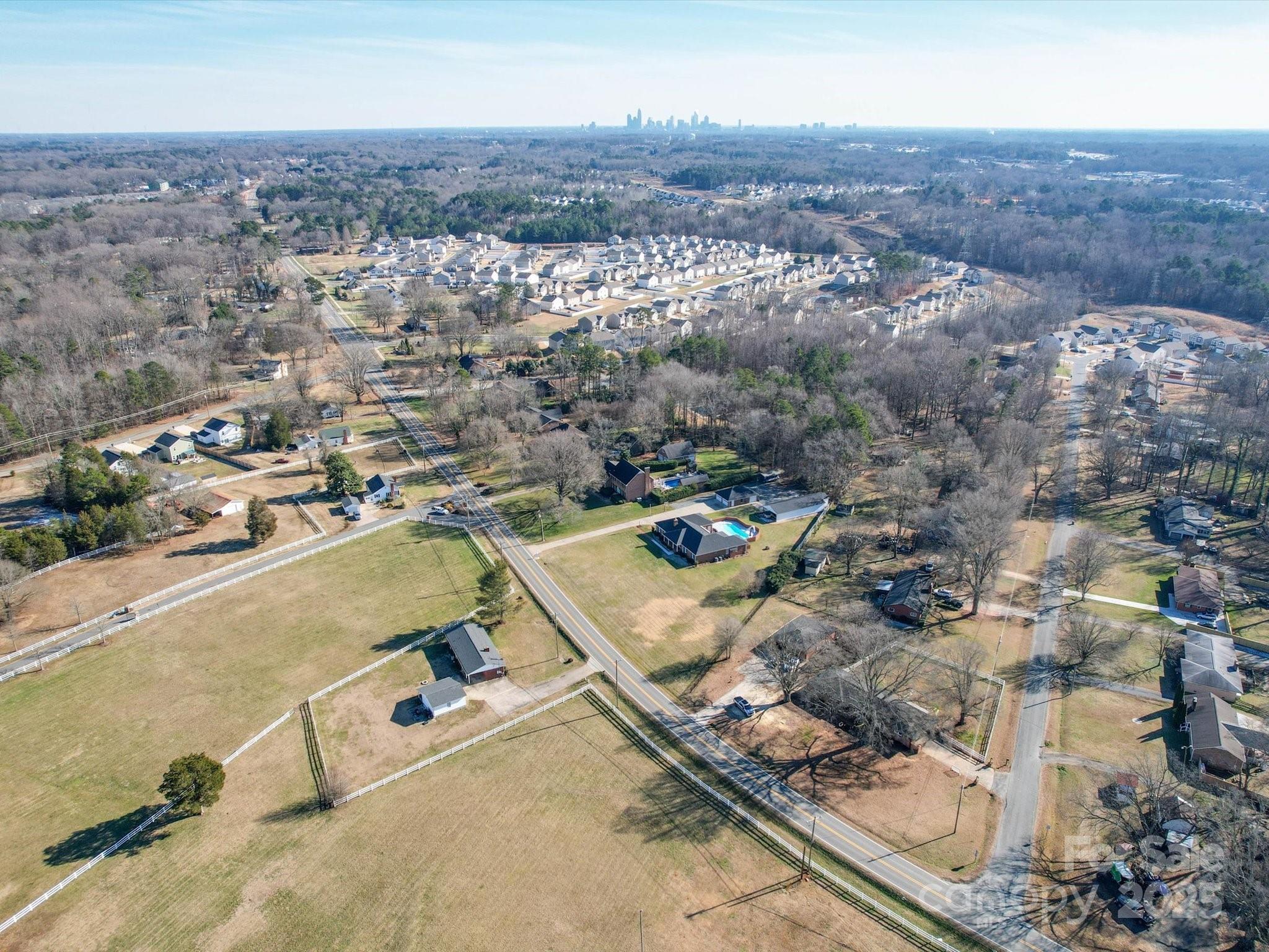 7169 Pleasant Grove Road Charlotte, NC 28216 - Photo 5 of 48 an aerial view of residential houses with outdoor space
