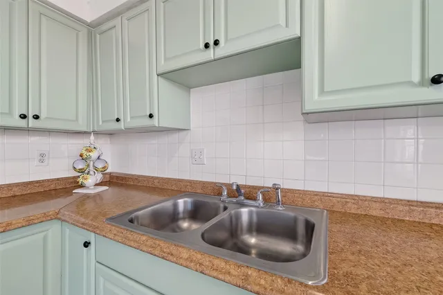 a kitchen with a sink and cabinets