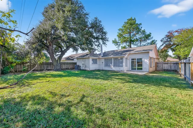 a view of a house with a backyard and a patio
