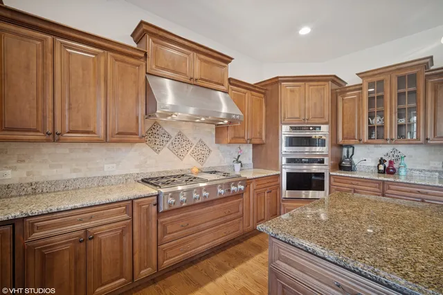 a kitchen with stainless steel appliances granite countertop a stove and a sink