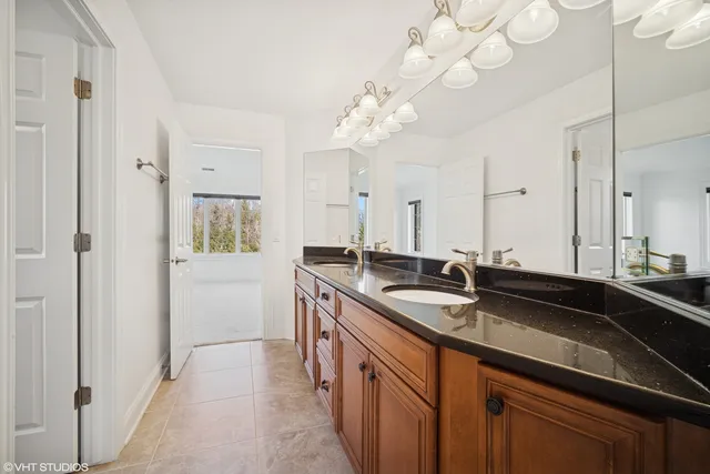 a kitchen with a sink and a chandelier