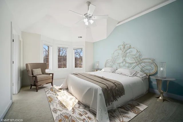 a bedroom with bed and a chandelier