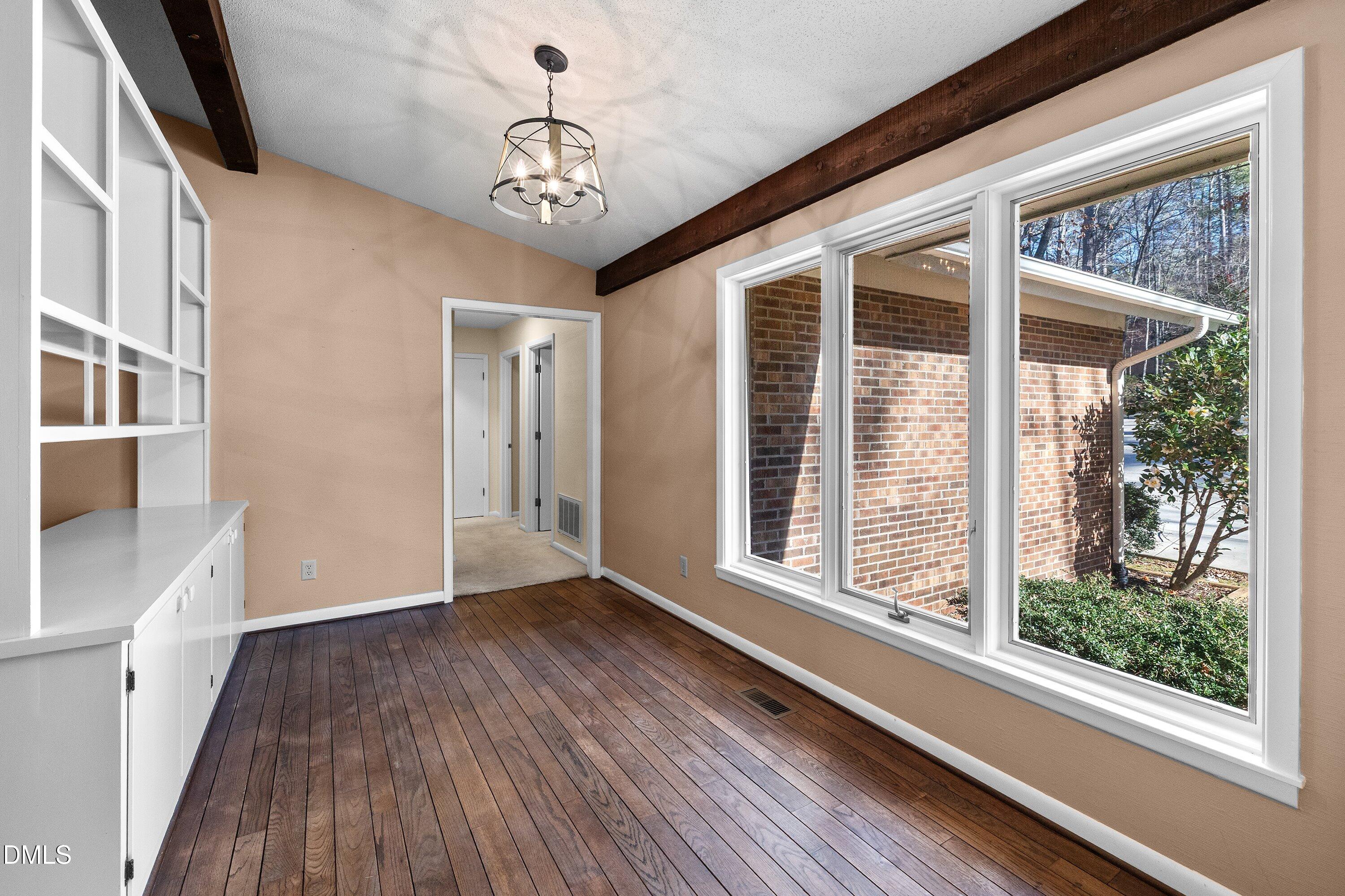 3113 Chipping Wedge Sanford, NC 27332 - Photo 9 of 42 a view of a room with wooden floor and windows