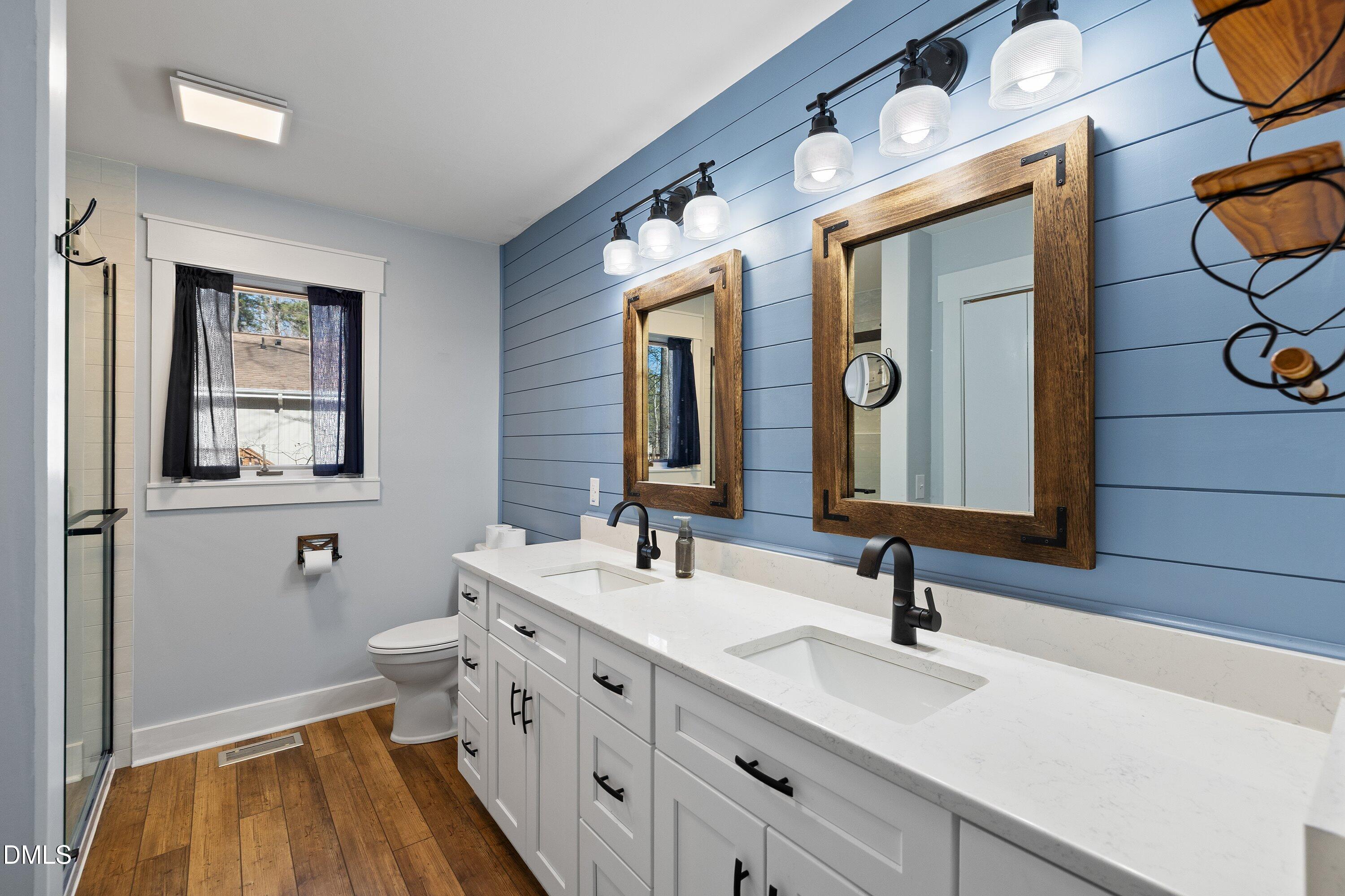 3113 Chipping Wedge Sanford, NC 27332 - Photo 11 of 42 a bathroom with a double vanity sink and a mirror