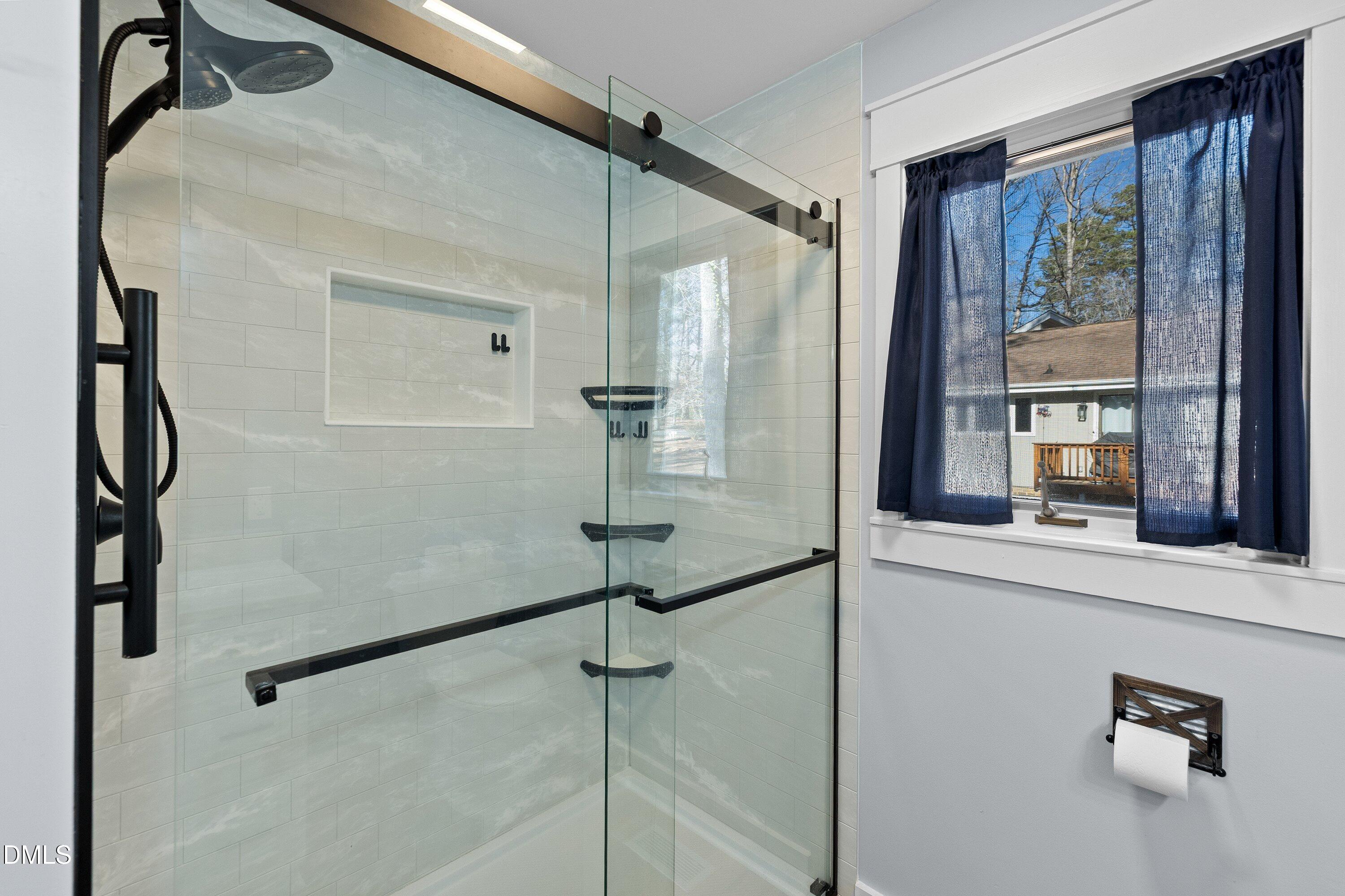 3113 Chipping Wedge Sanford, NC 27332 - Photo 12 of 42 a bathroom with a shower and a mirror