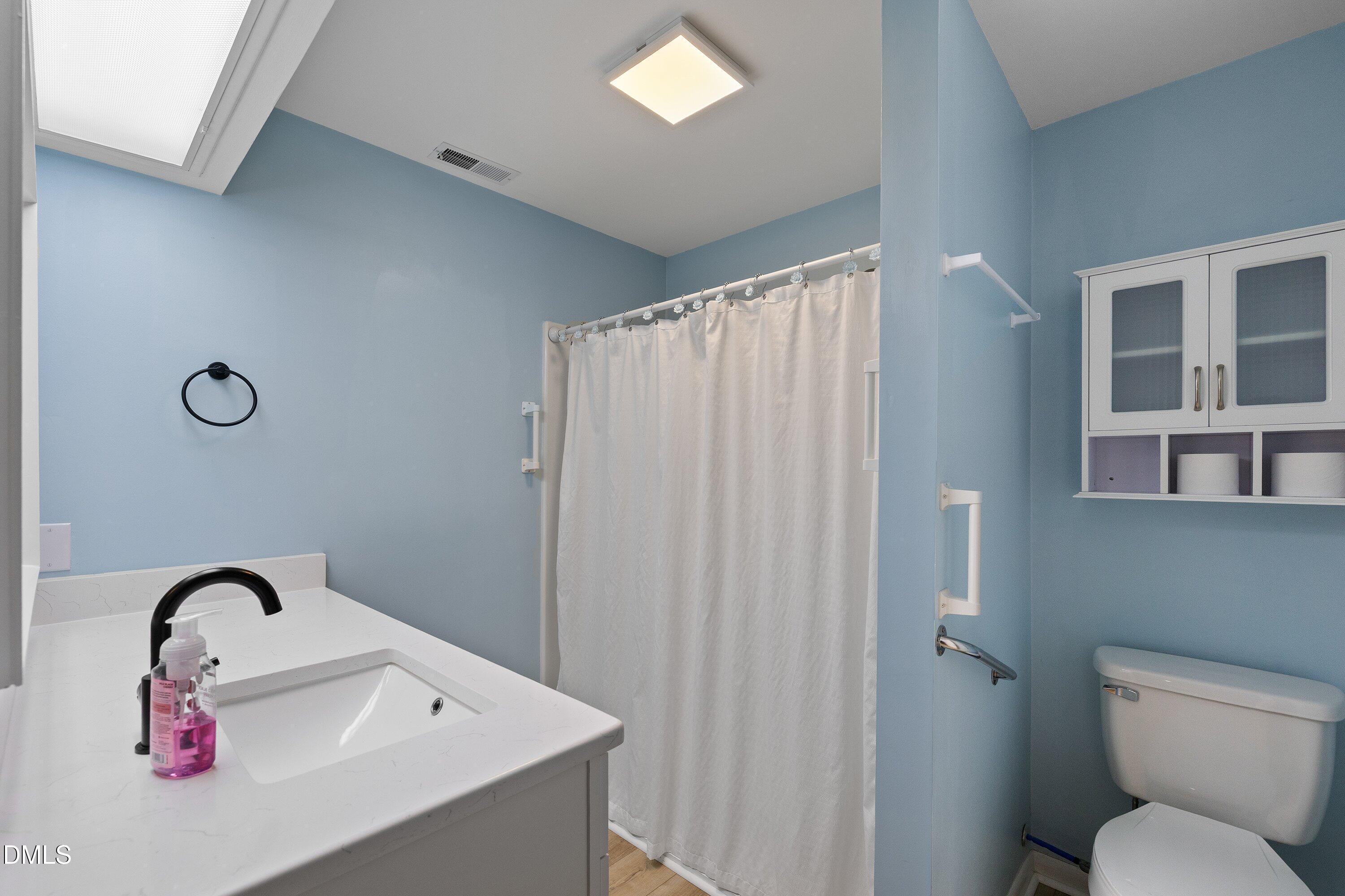 3113 Chipping Wedge Sanford, NC 27332 - Photo 21 of 42 a bathroom with a sink and toilet