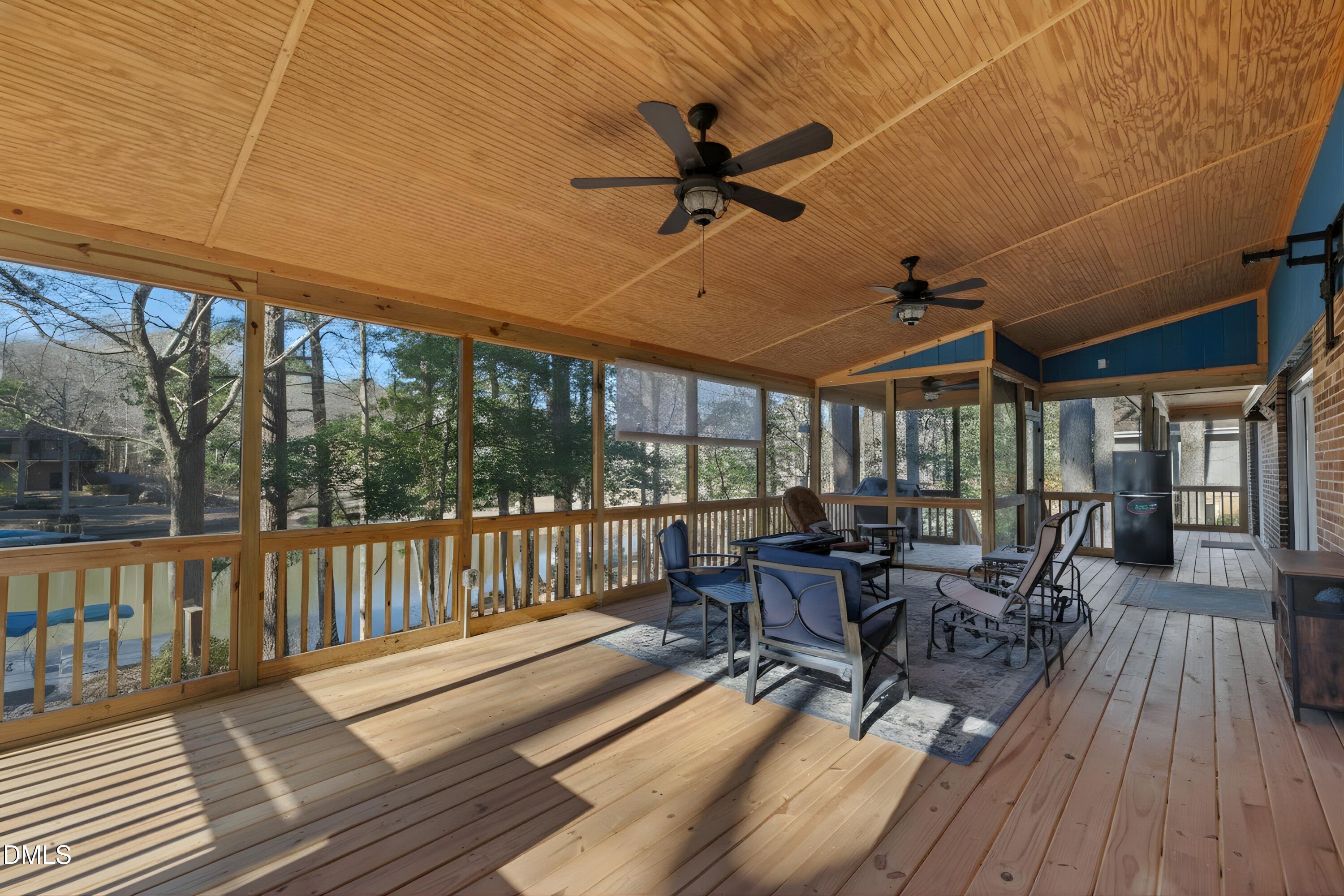3113 Chipping Wedge Sanford, NC 27332 - Photo 22 of 42 a view of a patio with wooden floor table and chairs