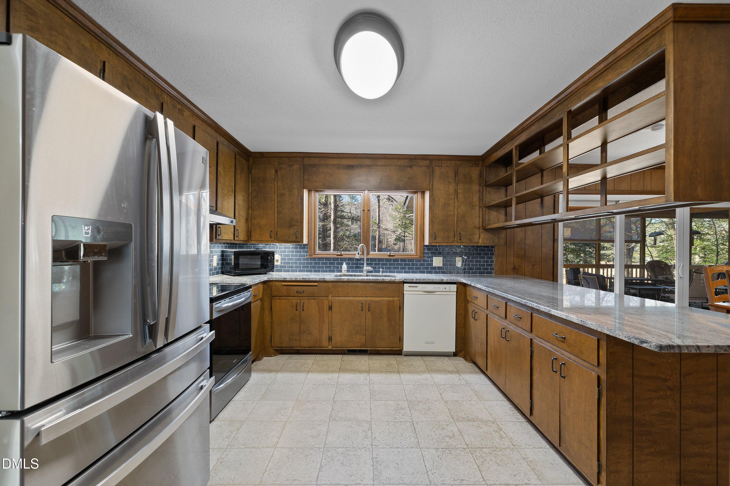3113 Chipping Wedge Sanford, NC 27332 - Photo 2 of 42 a large kitchen with a large window and stainless steel appliances