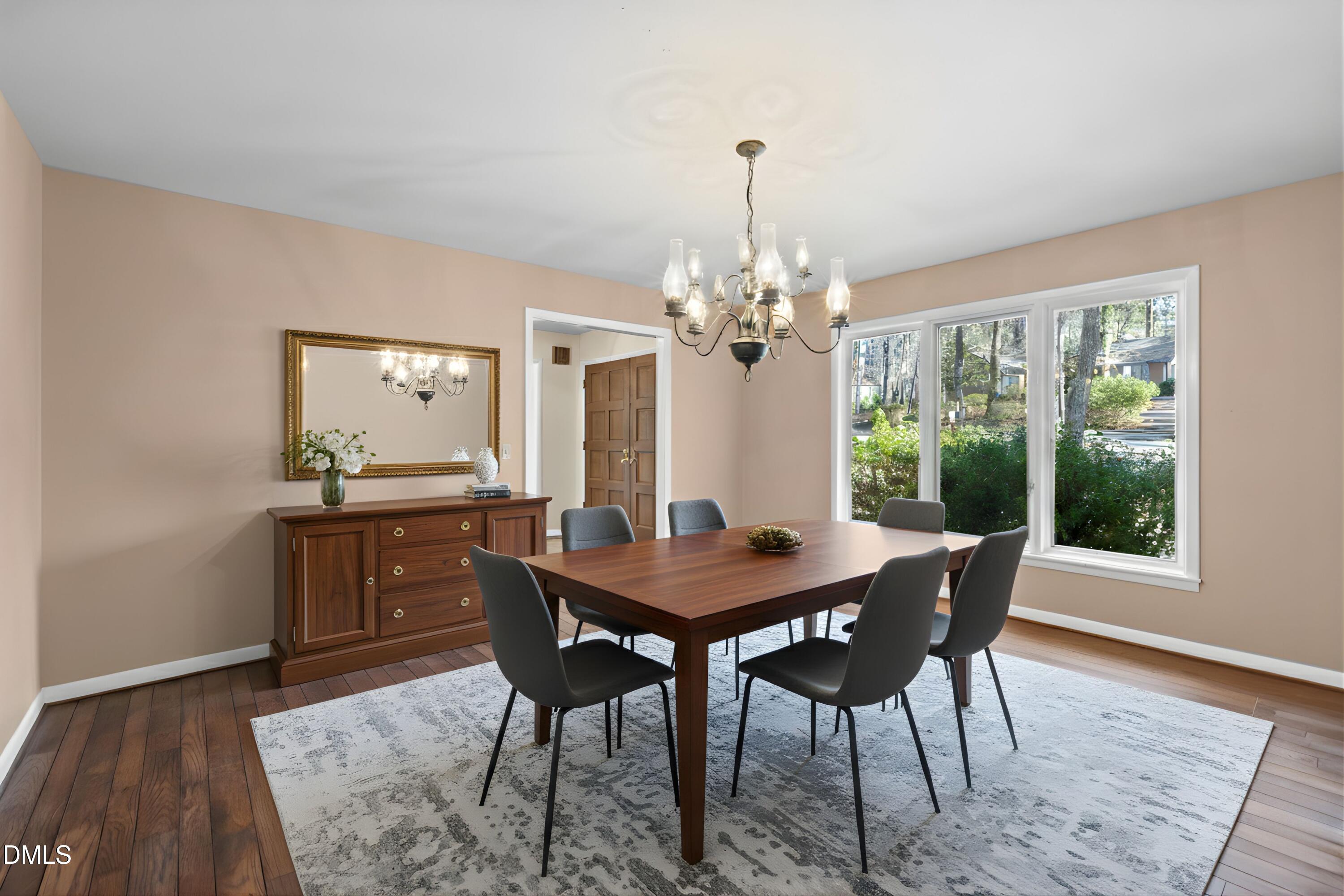 3113 Chipping Wedge Sanford, NC 27332 - Photo 3 of 42 a dining room with furniture a chandelier and wooden floor