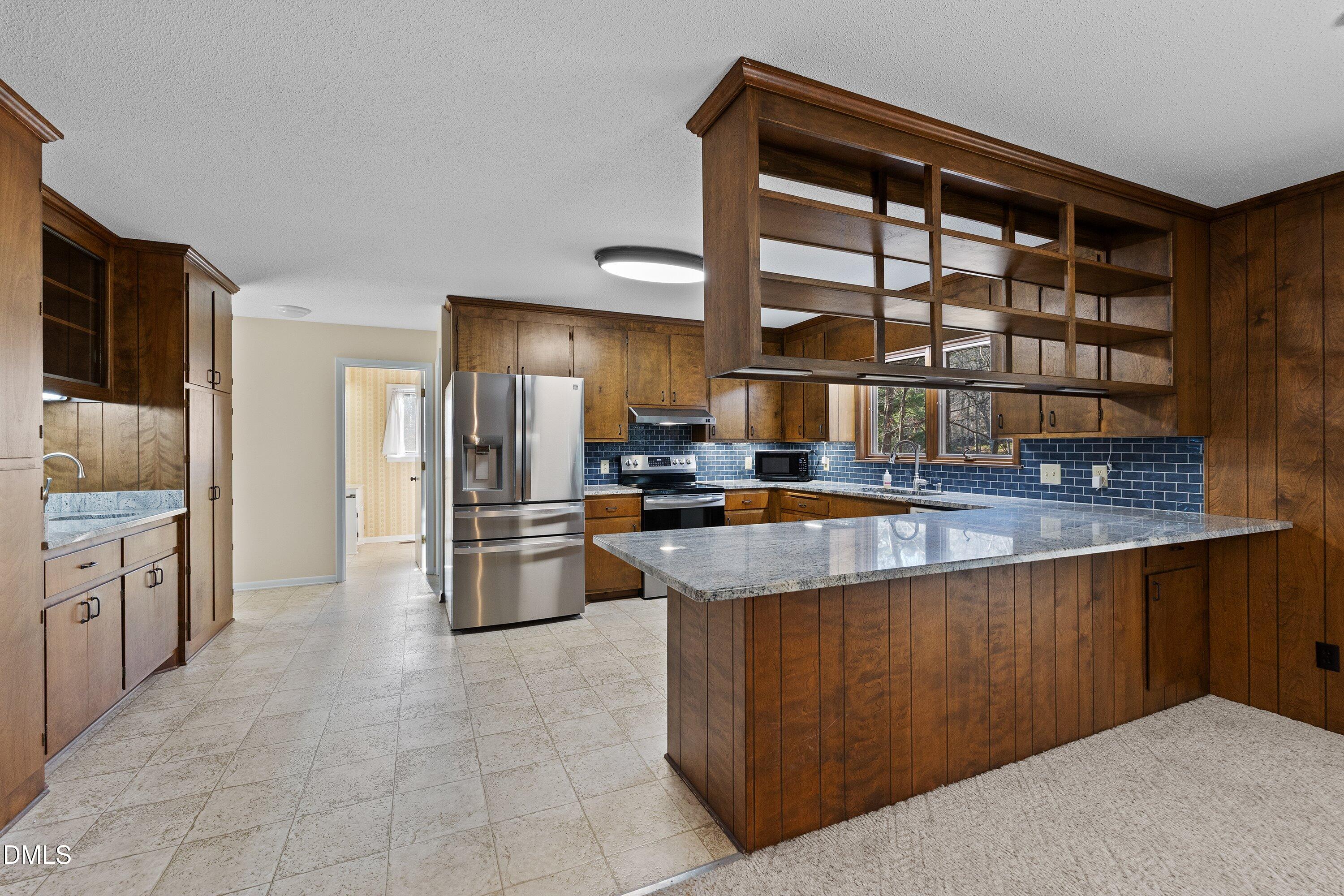 3113 Chipping Wedge Sanford, NC 27332 - Photo 6 of 42 a kitchen with stainless steel appliances granite countertop a stove and a refrigerator